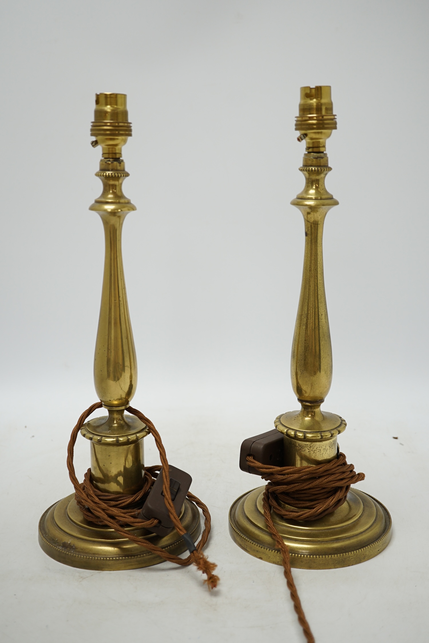 A pair of early 20th century brass table lamps, 36cm total height. Condition - fair, not tested